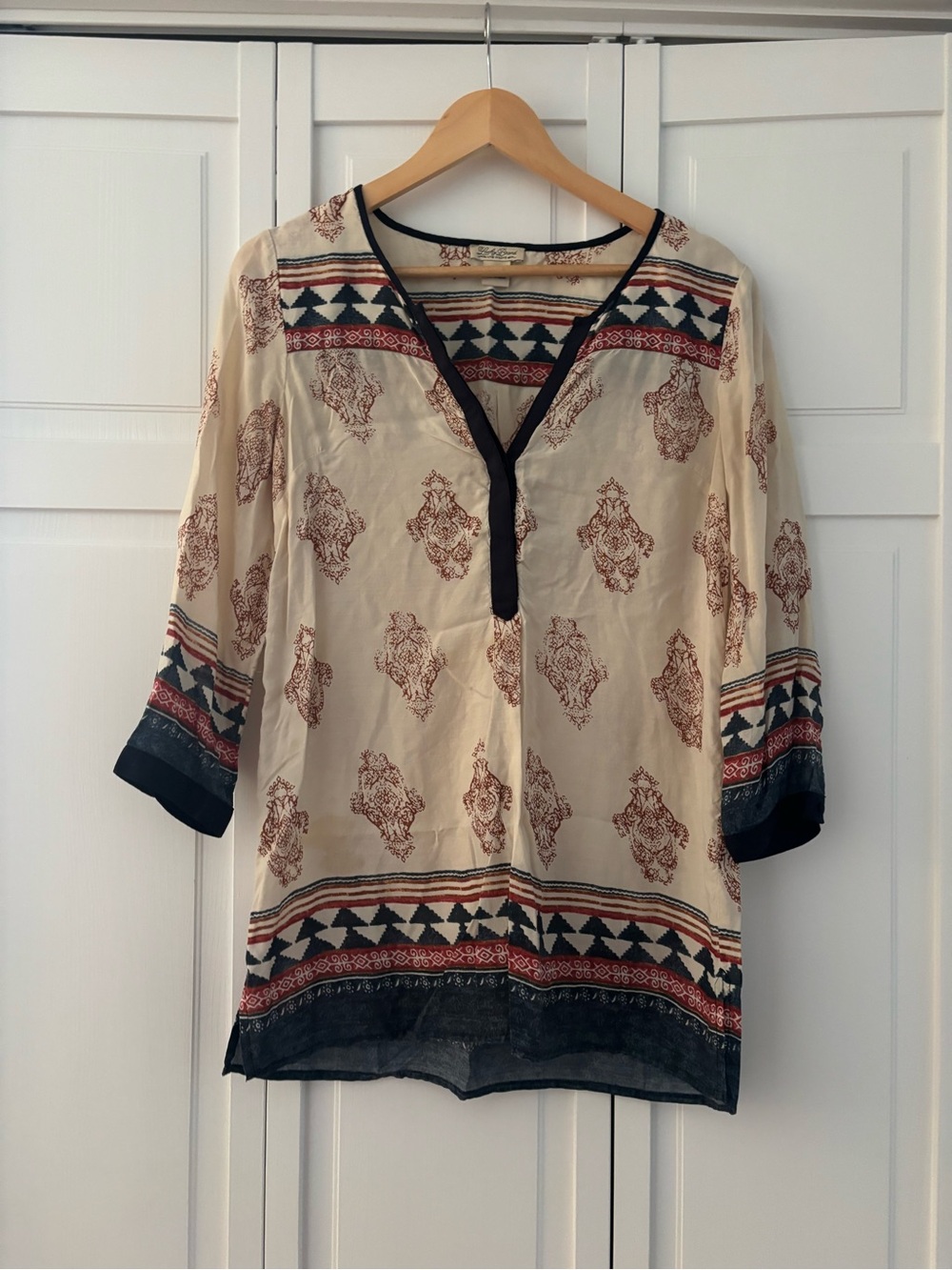 Cream blouse with blue and red details